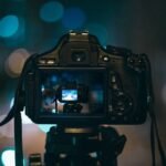 pexels-photo-90368-90368 Close-up of a DSLR camera capturing a bokeh background in a dimly lit setting, illustrating night photography.